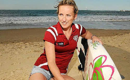 Ironwoman Aimee Berridge takes a close look at her paddle board which was hit by a whale off Mooloolaba. Ironwoman Aimee Berridge takes a close look at her paddle board which was hit by a whale off Mooloolaba.